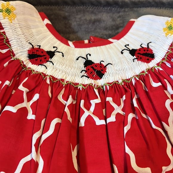 Hand Smocked Silly Goose Red Lady Bug Dress with Green liner on sleeves & bottom - Picture 2 of 3